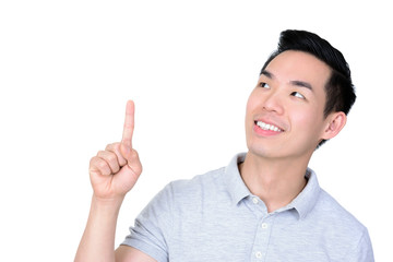 Smiling young Asian man looking and pointing up at empty space