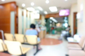 Blur hospital lobby with some people