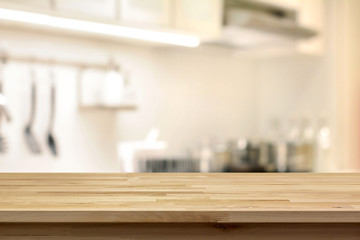 Wood table top (as kitchen island) on blur kitchen background