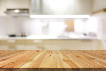 Natural pattern wood table top (or kitchen island) on blur kitchen interior background