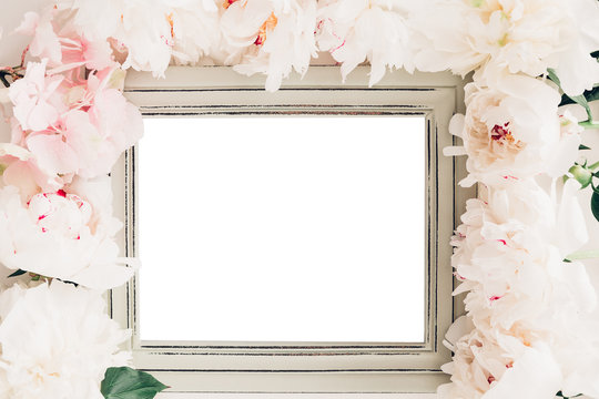 Pastel wooden frame decorated with peonies flowers, space for text. mock up