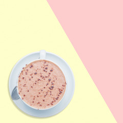 Hot chocolate on yellow and pink background.