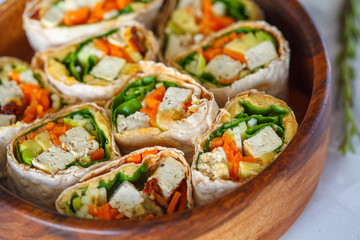 Healthy vegan tofu tortilla wraps with tofu and vegetables. Love for a healthy raw food concept.