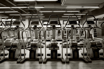 Row of Elliptical in gym. Black and white style.
