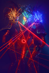 Fototapeta na wymiar Women in armor costumes with laser beams