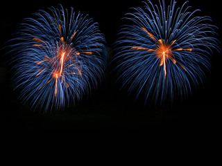Abstract fireworks light up in the sky at night