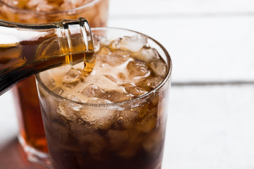Cola drink glass on white table