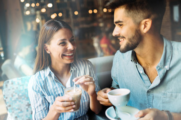 Young attractive couple on date in coffee shop