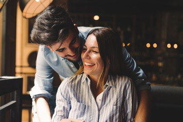 Young attractive couple on date in coffee shop