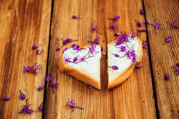 Closeup of flowering chives with shallow depth of field and focus concentrated on flower in the foreground