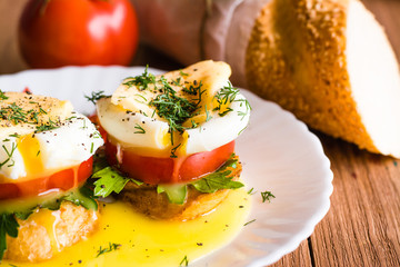 Sandwiches with poached egg, tomato, parsley and cheese