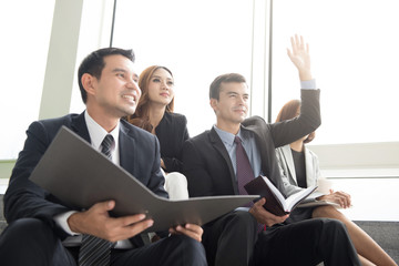 Business people sitting in group, sharing, meeting and learning