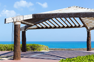 Wooden roof for shade on the shore of the Caribbean sea. Vacation concept image.