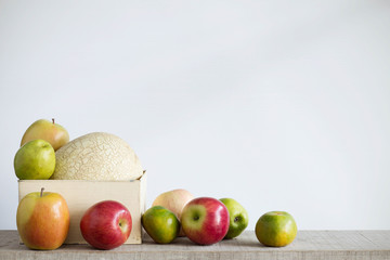Apples and melon with a white background.