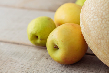 Apples on wooden floor.