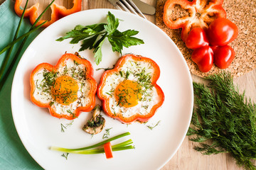 Funny face made of fried eggs, peppers, onions and mushrooms on a plate