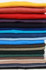 many colorful sweaters in a row..Still life of clothes, stack of sweater