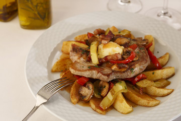 Pork and grilled vegetables arranged on a plate, Traditional dish in elegant setting, Selective focus with soft light