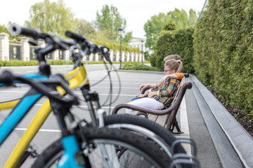 little kids embrasing while sitting on bench at park