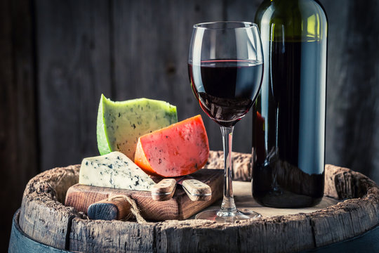 Closeup of red wine in glass and cheese