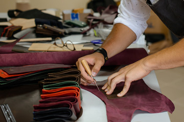 Leather handbag craftsman at work in a workshop