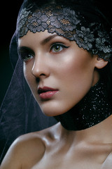 Beautiful girl with black lace veil