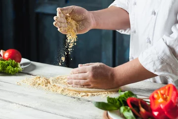 Wandaufkleber Closeup hand of chef baker in white uniform making pizza at kitchen © master1305