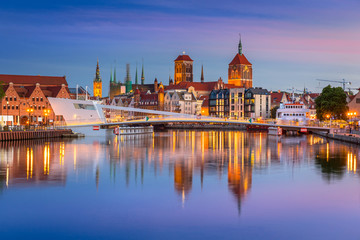 Fototapeta premium Old town in Gdansk and catwalk over Motlawa river at sunset, Poland