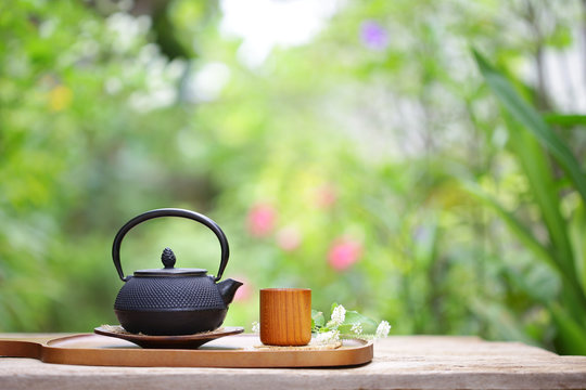 Black vintage teapot and cup at outside