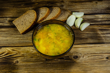 Vegetable soup in a glass bowl on wooden table