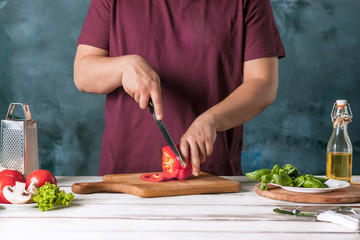 Closeup hand of chef baker making pizza at kitchen