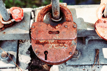 Close-up of rusty vintage padlocks on the pedestrian bridge fence.