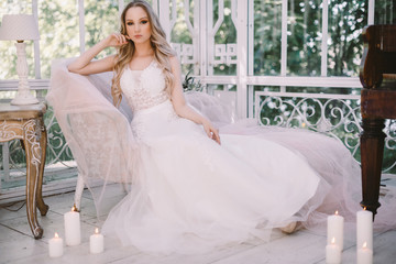 Portrait of Young Beautiful Attractive Bride with Flowers. White Dress and Wedding Decorations. 