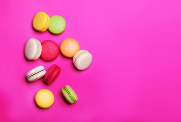 Sweet colorful macaroons on yellow background