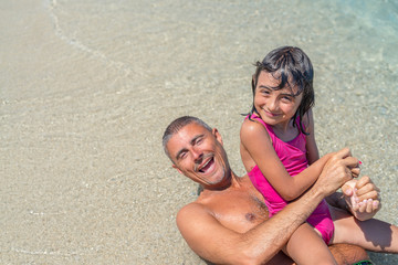 Fototapeta premium Happy young girl at sea border enjoying life with father