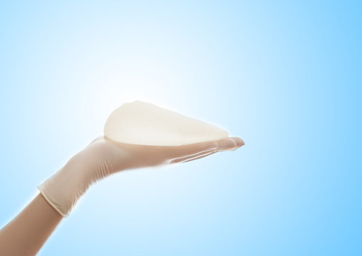 Silicone breast implant on hands
