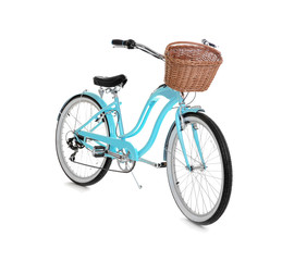 Modern bicycle with basket on white background