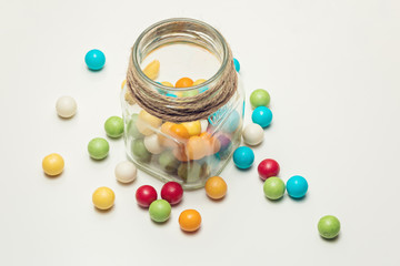 Colored chewing gum balls in container