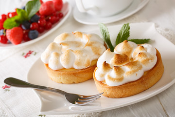 Lemon tart with meringue and mint closeup. horizontal
