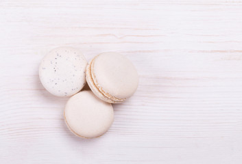 Fresh, cream-colored macaroons on a white background