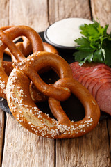 German traditional shorts, chopped sausages and garlic sauce close-up. vertical