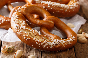 German meal: salted bread pretzel and pistachio close-up. Horizontal