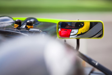 Pilot reflected in the rearviewer of his vehicle