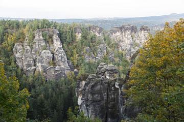 Big rock mountains in green forest in summer day