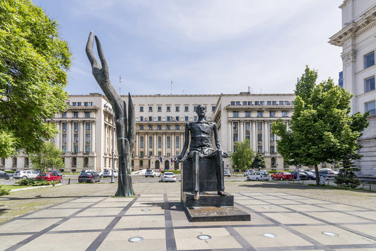 Hand and Broken Man Statues in Revolution Square, Bucharest, Romania, on a sunny day