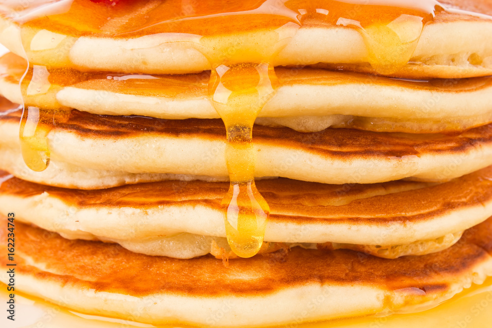 Wall mural texture of fresh pancakes with fragrant maple syrup and honey.