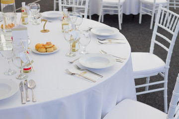 fancy table set for a wedding dinner, white chairs
