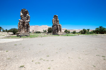 Egypt. Luxor. The Colossi of Memnon - two massive stone statues of Pharaoh Amenhotep III