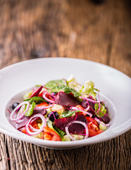 Vegetable salad. Plate of salad with vegetables  on rustic oak table. Assortment of ingredients of vegetable salad.