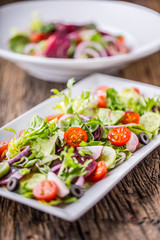 Vegetable salad. Plate of salad with vegetables  on rustic oak table. Assortment of ingredients of vegetable salad.